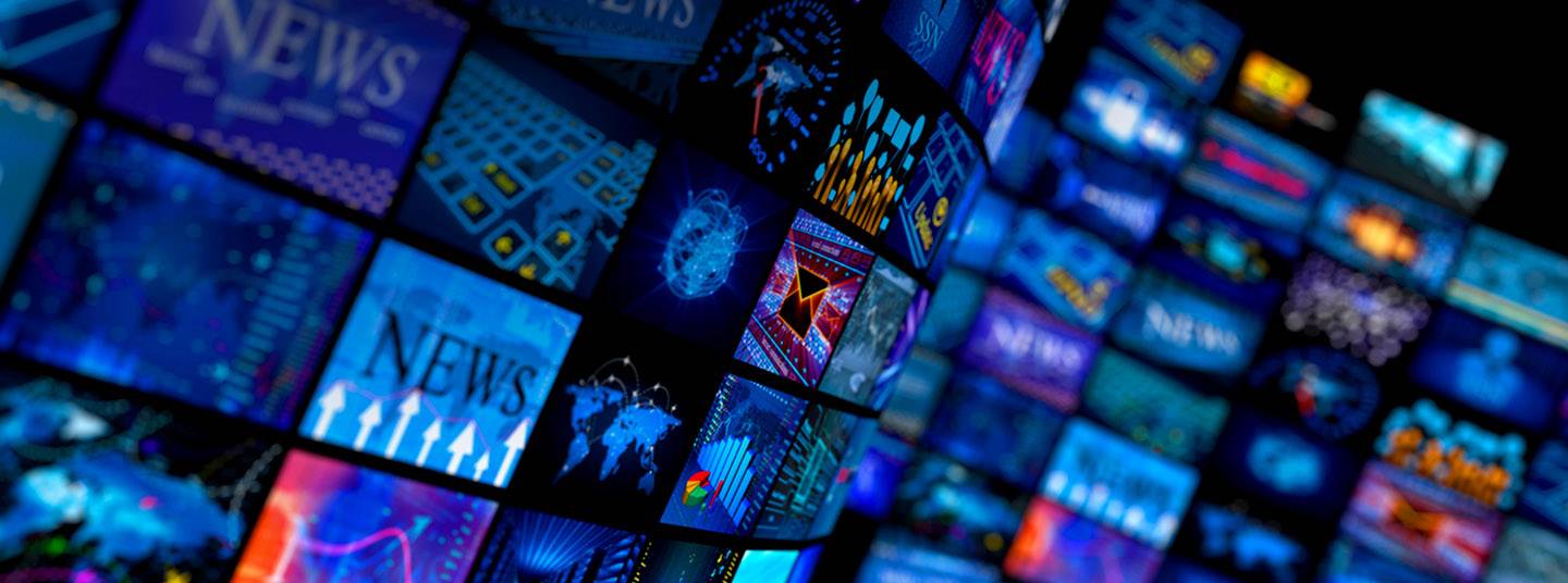 A wall of TV screens, each showing a different image.  
