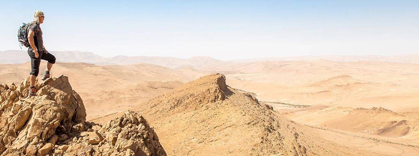 Youths playing in a fountain with red and blue sand buckets.