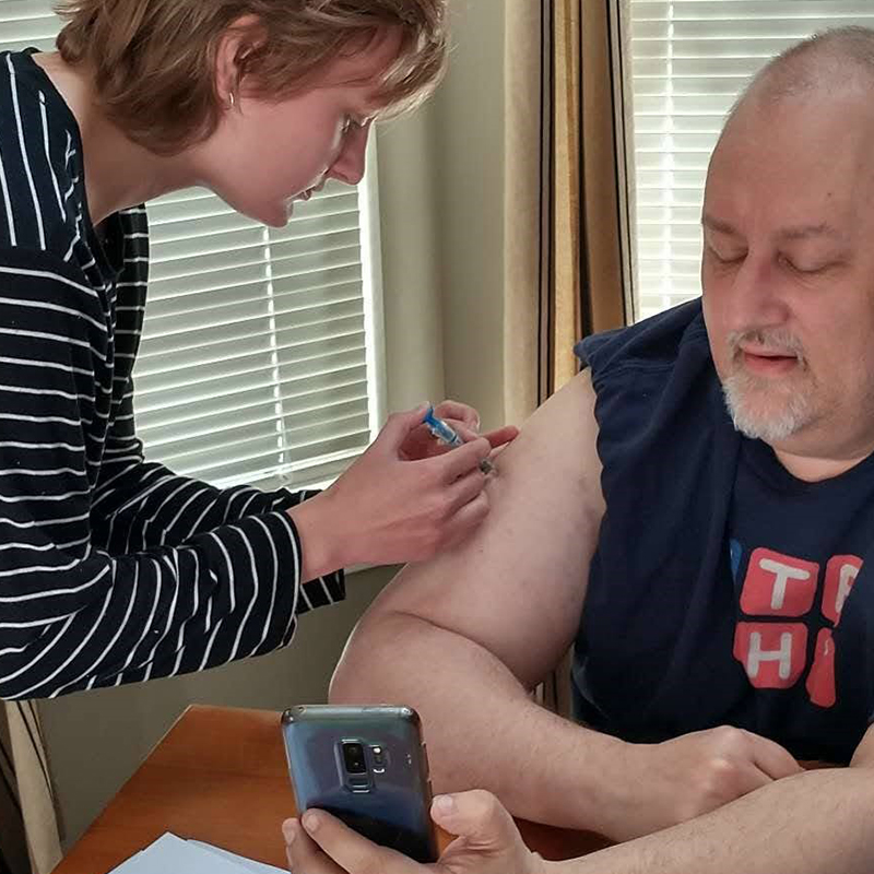 Steve Neruda receiving an injection - administered by his daughter - to prepare his blood for a bone marrow transplant.